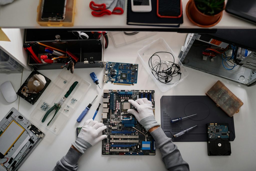 Workplace of Electronic Repairman Fixing Malfunctioning Computer